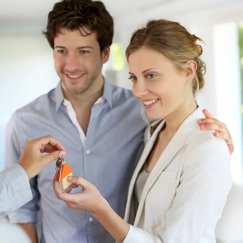 A nurse and her partner receiving the keys to their new home.