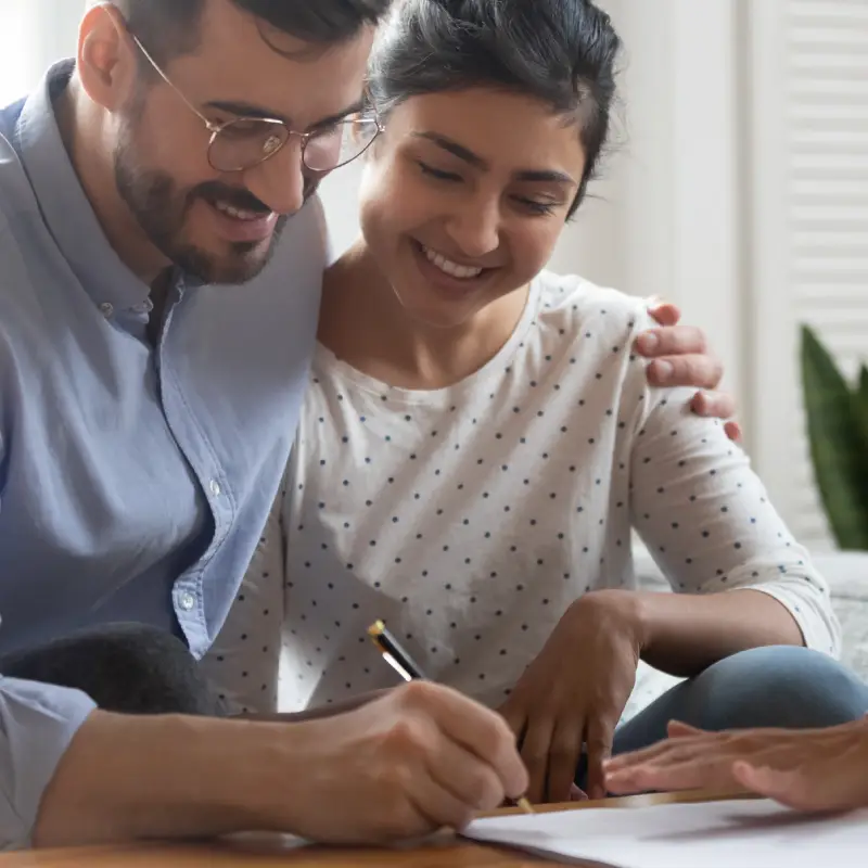 Couple signing their investment property documents