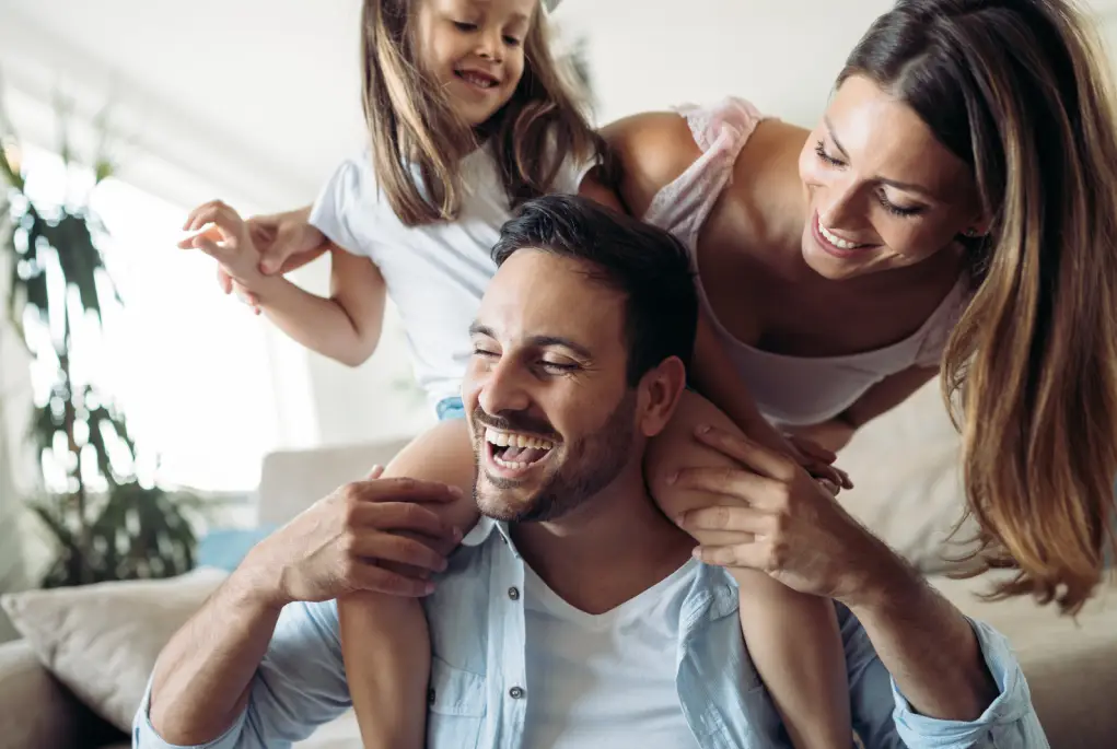 A family of 3 smiling after their Home Loan refinance.