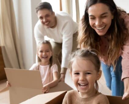 Couple and their two daughters celebrating their first home purchase
