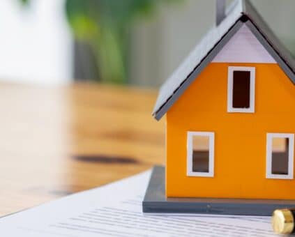 Orange house sitting on contracts for a home loan refinance