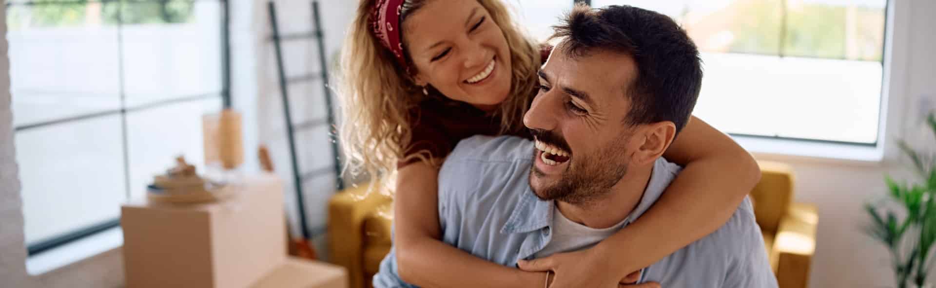 Happy couple moving into their new home after settling their bad credit home loan