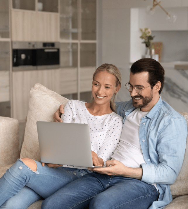 Happy couple on their laptop looking for bad credit home loans