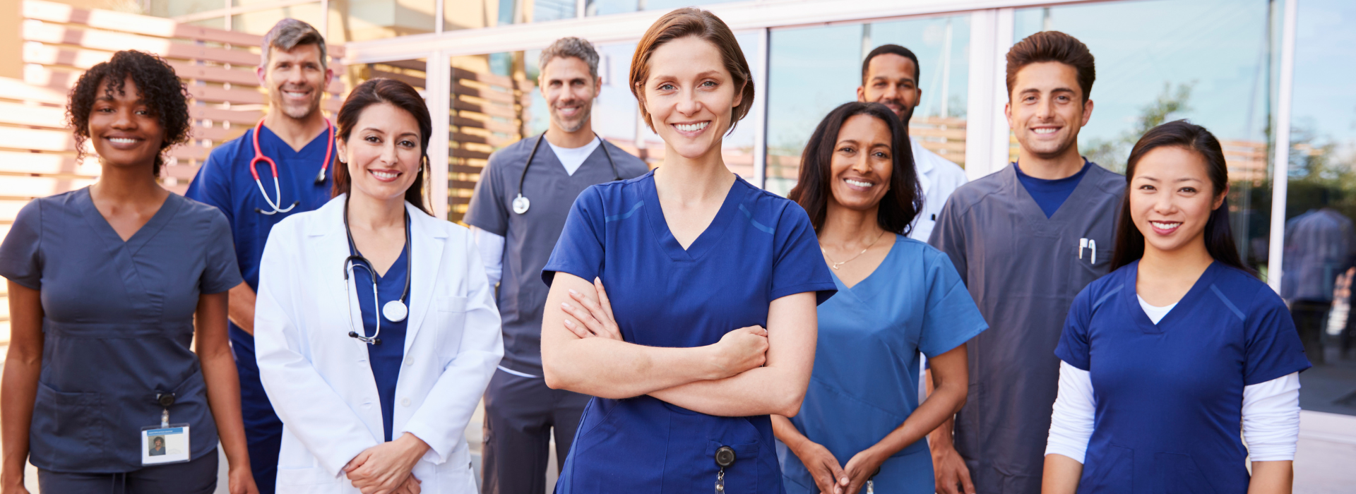 Diverse team of healthcare professionals including nurses and doctors standing together, representing eligible applicants for specialised healthcare worker home loans
