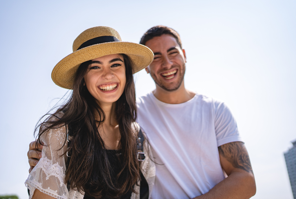 Smiling young couple outdoors representing first home buyers who may benefit from guarantor home loan support from family