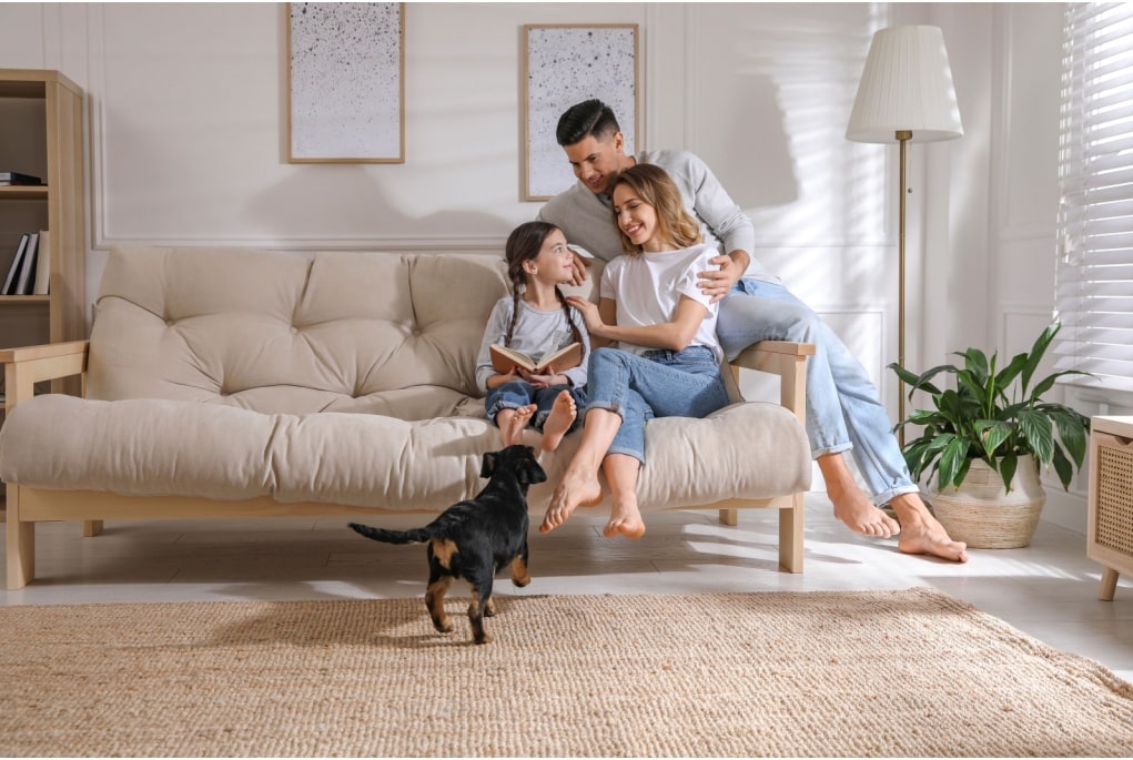 happy family with their dog in their new home
