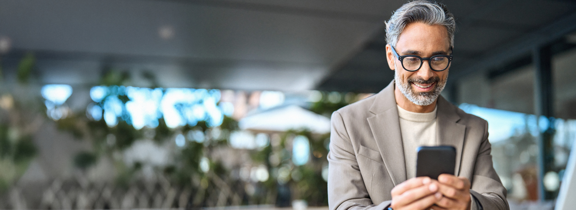 Man on his phone applying for a self managed super fund (SMSF) home loan