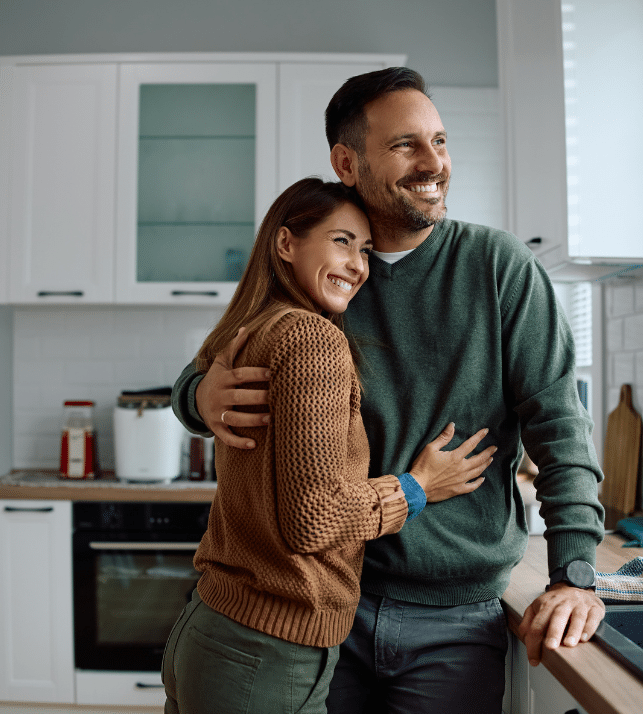 Happy couple in new home purchased with SMSF home loan