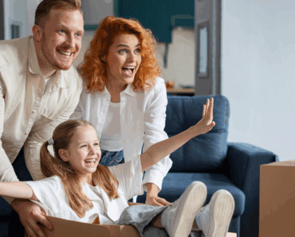 Family moving into a new home surrounded by cardboard boxes, symbolizing the fresh start made possible with a home loan.