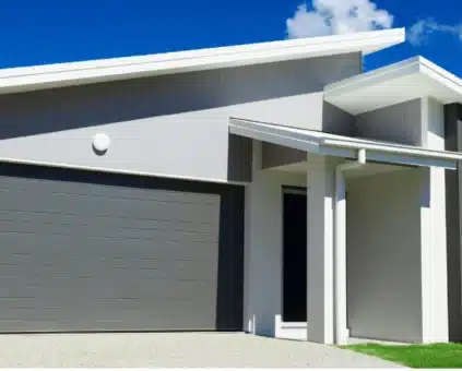 Modern Australian home with gray garage door and white exterior, representing low doc home loan opportunities