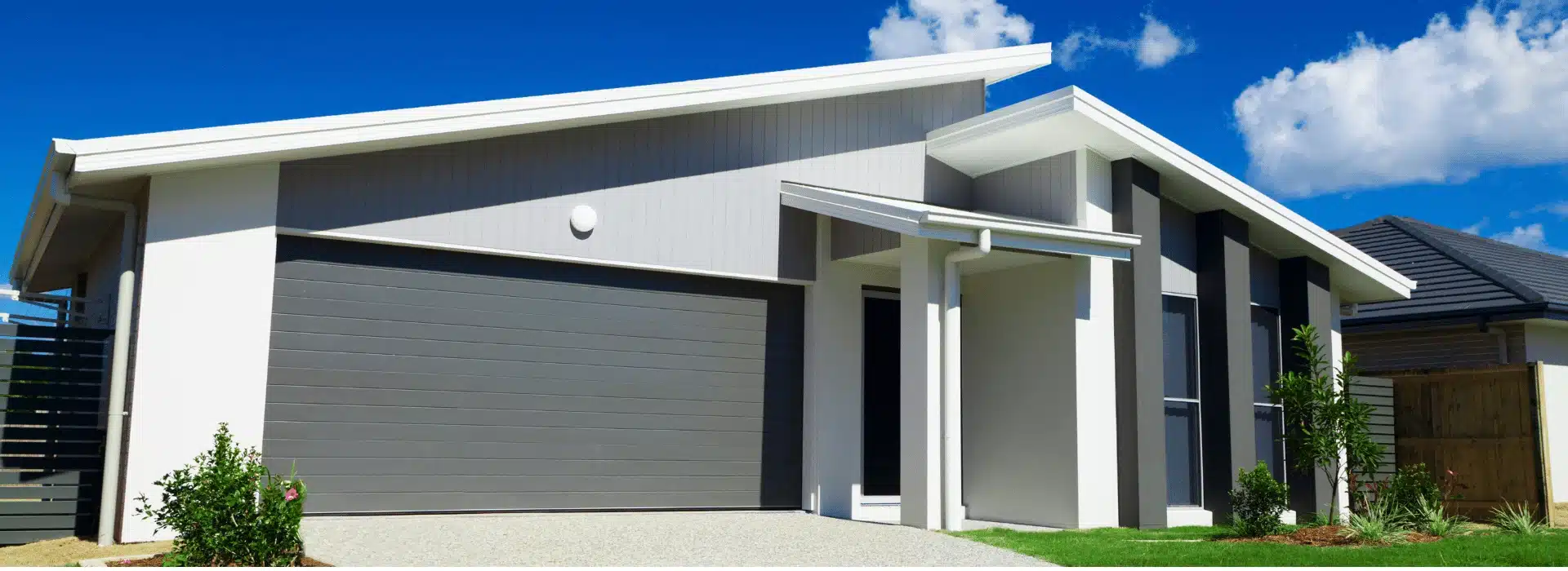Modern Australian home with gray garage door and white exterior, representing low doc home loan opportunities