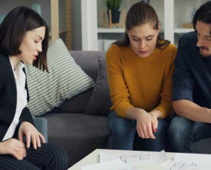 Fox Home Loans broker reviewing home loan options with a Sunshine Coast couple at a Maroochydore kitchen table