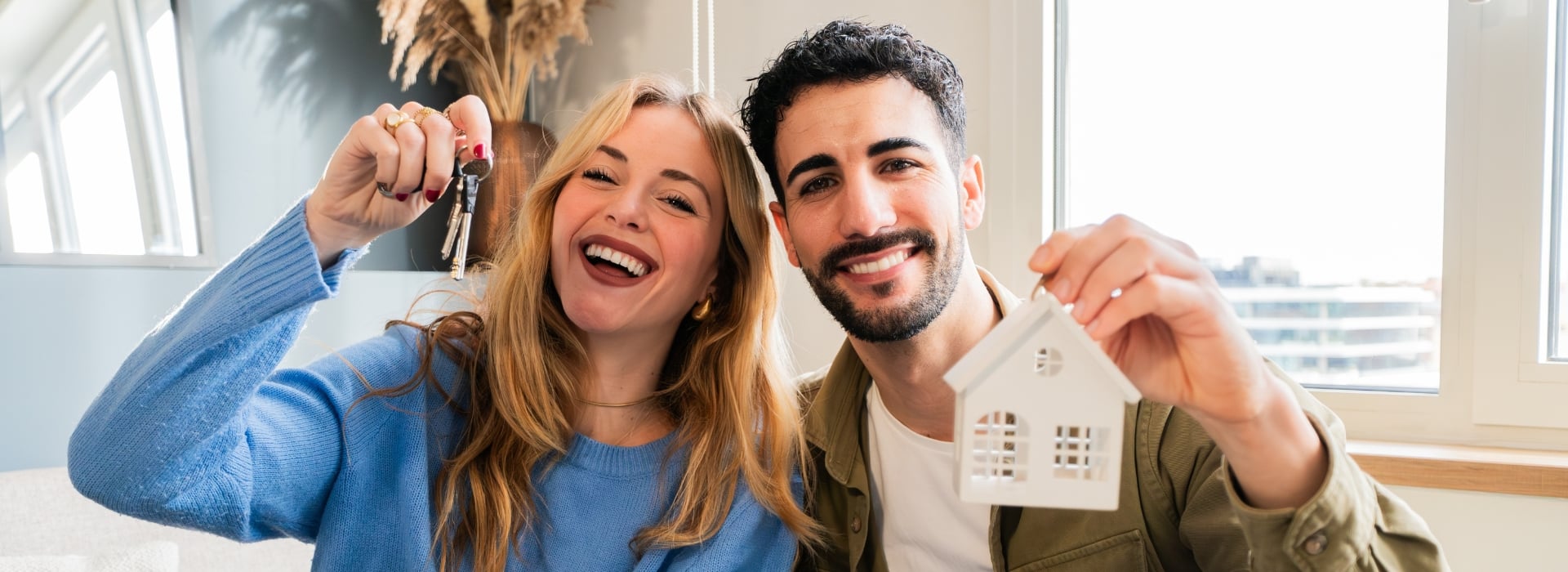 Couple celebrating purchasing a first home