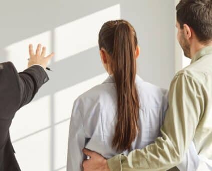 Real estate agent showing a couple around a home Australia