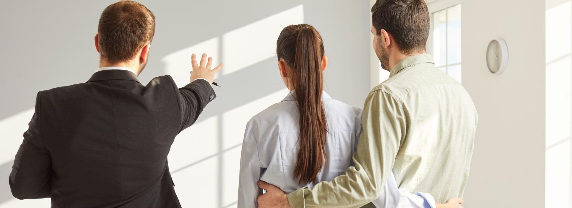 Real estate agent showing a couple around a home Australia