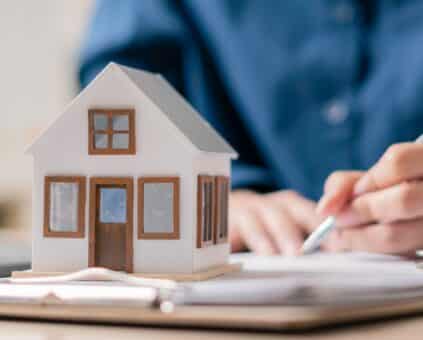 homeowner sitting at a kitchen table reviewing home loan paperwork
