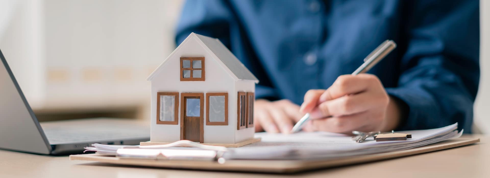 homeowner sitting at a kitchen table reviewing home loan paperwork
